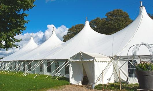 a line of portable restrooms in a shaded area, offering a comfortable experience for users in Kinards